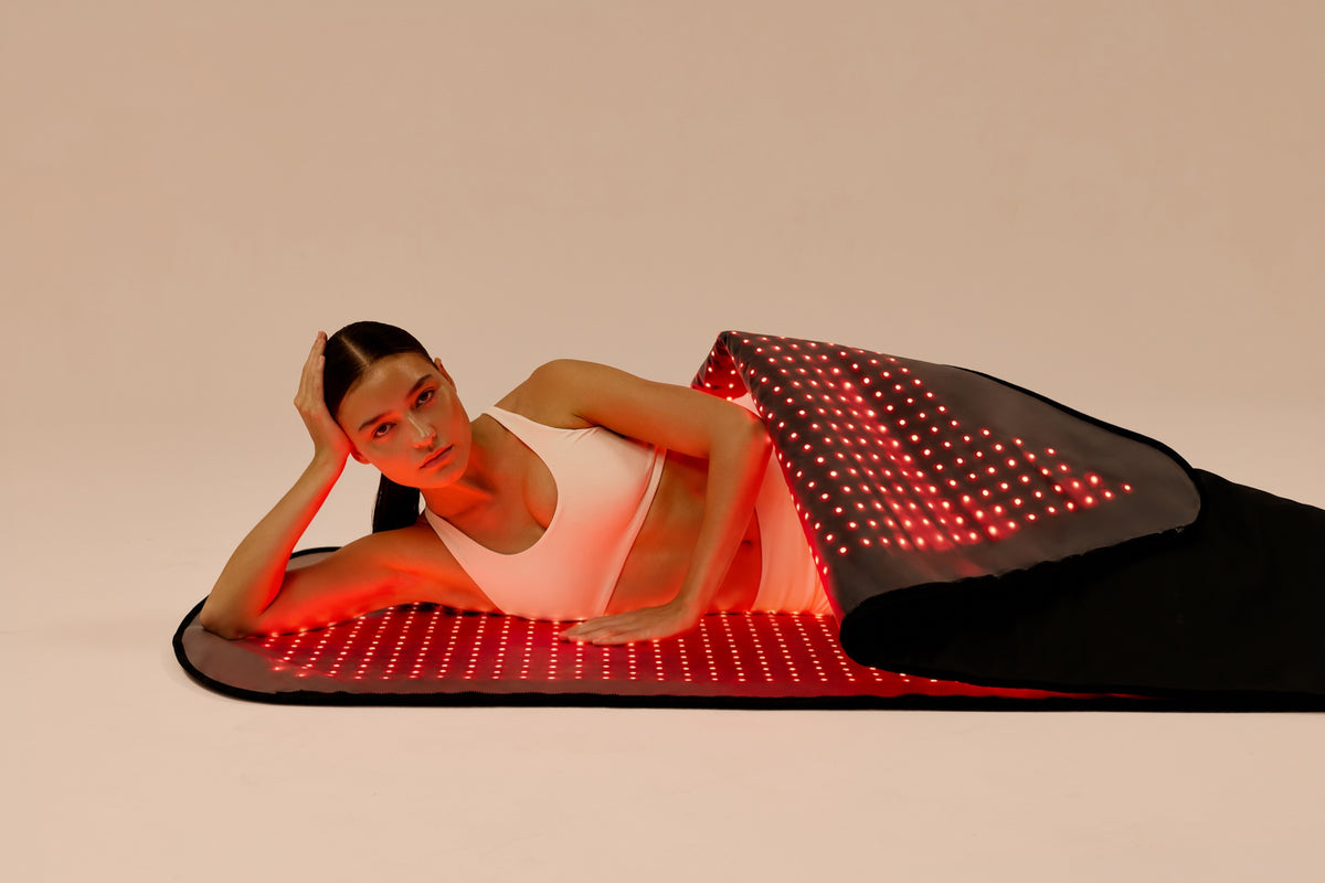 Woman resting inside the Restora+ red light therapy pod